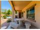 Covered patio has a stone table and integrated stone benches, with a pool and grill in the background at 194 E Canyon Creek Dr, Gilbert, AZ 85295