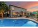 Backyard pool view with patio, an umbrella covered table, a barbeque grill, and trees at 194 E Canyon Creek Dr, Gilbert, AZ 85295