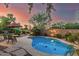 Inviting backyard pool featuring lush landscaping and a cozy seating area at 194 E Canyon Creek Dr, Gilbert, AZ 85295