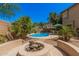 Inviting backyard featuring a pool, fire pit, and lush landscaping at 194 E Canyon Creek Dr, Gilbert, AZ 85295