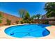 Inviting swimming pool with clear blue water, surrounded by well-maintained landscaping and brick walls at 194 E Canyon Creek Dr, Gilbert, AZ 85295