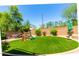 Beautiful lawn with artificial turf, playset and privacy landscaping with a perimeter wall at 194 E Canyon Creek Dr, Gilbert, AZ 85295