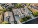 An aerial view of a house featuring a backyard pool, solar panels and desert landscaping in a sunny neighborhood at 2556 E Quiet Hollow Ln, Phoenix, AZ 85024
