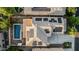 An aerial close up showing a solar-paneled roof, pool, deck, and desert landscaping in the backyard at 2556 E Quiet Hollow Ln, Phoenix, AZ 85024