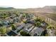 Aerial view showcases the home's position with desert landscaping, solar panels, mountain backdrop and neighborhood setting at 2556 E Quiet Hollow Ln, Phoenix, AZ 85024