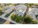 Aerial view showcases the home's position with desert landscaping, long driveway, and solar panels at 2556 E Quiet Hollow Ln, Phoenix, AZ 85024