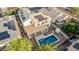 Aerial view of a backyard with a covered patio, a blue swimming pool, and several solar panels on the roof at 2556 E Quiet Hollow Ln, Phoenix, AZ 85024