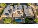 Drone shot of a backyard with a sparkling pool, covered patio area, and solar panels, perfect for relaxation and sustainability at 2556 E Quiet Hollow Ln, Phoenix, AZ 85024