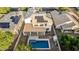 Aerial view of a backyard featuring a swimming pool, covered patio, and solar panels atop a well-maintained home at 2556 E Quiet Hollow Ln, Phoenix, AZ 85024