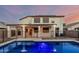 A serene backyard featuring a sparkling pool, covered patio, and secure black metal fencing at 2556 E Quiet Hollow Ln, Phoenix, AZ 85024