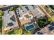 High-angle view of a residence featuring a backyard pool, a covered patio, and energy-saving solar panels on its roof at 2556 E Quiet Hollow Ln, Phoenix, AZ 85024