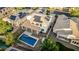 Aerial shot of a home with a pool, covered patio, and solar panels, highlighting outdoor living and energy efficiency at 2556 E Quiet Hollow Ln, Phoenix, AZ 85024