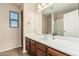 A light bathroom includes a built-in vanity and a large mirror at 2556 E Quiet Hollow Ln, Phoenix, AZ 85024