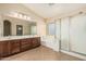 Well-lit bathroom with double vanity, garden tub, and glass-enclosed shower at 2556 E Quiet Hollow Ln, Phoenix, AZ 85024