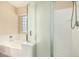Modern bathroom with tub, glass shower, frosted glass window, and tile floors at 2556 E Quiet Hollow Ln, Phoenix, AZ 85024