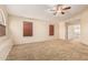 Spacious carpeted bedroom with multiple windows, ceiling fan, and neutral color scheme at 2556 E Quiet Hollow Ln, Phoenix, AZ 85024