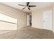 A beige bedroom includes a ceiling fan, neutral colored walls, and white doors at 2556 E Quiet Hollow Ln, Phoenix, AZ 85024