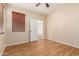 Comfortable bedroom features wood-look flooring and ample natural light from the window at 2556 E Quiet Hollow Ln, Phoenix, AZ 85024