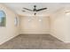 Carpeted bedroom with neutral paint and a dark ceiling fan at 2556 E Quiet Hollow Ln, Phoenix, AZ 85024