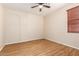 Cozy bedroom with ceiling fan, wood-look flooring, and a neutral color scheme at 2556 E Quiet Hollow Ln, Phoenix, AZ 85024