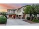 Charming two-story home with a three-car garage, beautiful windows, and a well-maintained yard at 2556 E Quiet Hollow Ln, Phoenix, AZ 85024