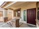 Charming front porch with stone accents, covered entry, and a stylish, paneled front door at 2556 E Quiet Hollow Ln, Phoenix, AZ 85024