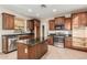 Spacious kitchen with wood cabinets, tile floor, granite counters, and stainless steel appliances at 2556 E Quiet Hollow Ln, Phoenix, AZ 85024