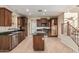 Traditional kitchen featuring wood cabinets, tile floors, granite countertops, and a center island at 2556 E Quiet Hollow Ln, Phoenix, AZ 85024