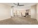 Carpeted loft area with dark ceiling fan and staircase at 2556 E Quiet Hollow Ln, Phoenix, AZ 85024