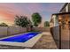 Backyard pool with a black fence and covered patio, perfect for outdoor relaxation and entertaining at 2556 E Quiet Hollow Ln, Phoenix, AZ 85024