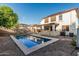 Inviting backyard pool with covered patio and surrounding landscaping for relaxation and entertaining at 2556 E Quiet Hollow Ln, Phoenix, AZ 85024