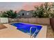 Backyard pool with ladder, surrounded by a block wall, and ample space for lounging at 2556 E Quiet Hollow Ln, Phoenix, AZ 85024