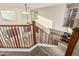 This is a beautiful staircase with wood and black iron banister and carpeted steps leading to the downstairs area at 2556 E Quiet Hollow Ln, Phoenix, AZ 85024