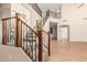 A carpeted staircase includes a wood and wrought iron railing and hardwood floors at 2556 E Quiet Hollow Ln, Phoenix, AZ 85024