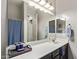 Bathroom vanity with a wide mirror, dark cabinetry, white counter tops and silver fixtures at 2618 E Stacey Rd, Gilbert, AZ 85298