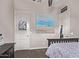 Bedroom with neutral walls, carpet, a queen bed, and a framed ocean-themed painting at 2618 E Stacey Rd, Gilbert, AZ 85298