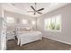 Bright bedroom featuring neutral walls, a ceiling fan, shutters and a well-appointed queen-sized bed with storage drawers at 2618 E Stacey Rd, Gilbert, AZ 85298