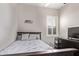 Bedroom featuring a queen bed, ceiling fan, window with shutter and a decorative Seahawks logo at 2618 E Stacey Rd, Gilbert, AZ 85298