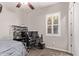 Bedroom with carpet, a ceiling fan, a window with shutter, desk area and gray bedding at 2618 E Stacey Rd, Gilbert, AZ 85298