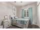 Cozy bedroom featuring a bed with decorative pillows and a large window with teal curtains at 2618 E Stacey Rd, Gilbert, AZ 85298
