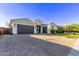 Wide driveway leading to a two-car attached garage with desert landscaping at 2618 E Stacey Rd, Gilbert, AZ 85298