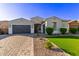 Attractive home featuring an attached garage, manicured lawn, and desert landscaping at 2618 E Stacey Rd, Gilbert, AZ 85298