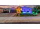 Beautiful single-story home featuring a well-maintained lawn, desert landscaping, and a two car garage at 2618 E Stacey Rd, Gilbert, AZ 85298