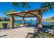 Covered gazebo overlooking the tranquil pond, offering a peaceful spot for relaxation and picnics at 2618 E Stacey Rd, Gilbert, AZ 85298