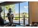 Gym featuring exercise equipment in front of a bright window with stunning lake and community views at 2618 E Stacey Rd, Gilbert, AZ 85298