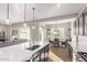 Open-concept kitchen with a large island, stainless steel sink, and seamless flow to dining at 2618 E Stacey Rd, Gilbert, AZ 85298