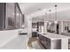 Modern kitchen with a large island, stainless steel appliances, and open layout to living area at 2618 E Stacey Rd, Gilbert, AZ 85298