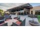 Outdoor patio area with comfortable seating arrangements and an exterior fireplace at 2618 E Stacey Rd, Gilbert, AZ 85298