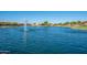Scenic view of a serene pond with fountains, creating a relaxing atmosphere in the community at 2618 E Stacey Rd, Gilbert, AZ 85298