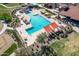 Aerial view of a community pool featuring lounge chairs, shaded seating, and well-maintained landscaping at 2618 E Stacey Rd, Gilbert, AZ 85298